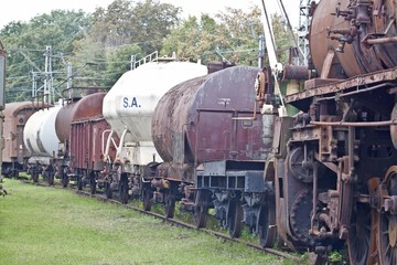 Fototapeta na wymiar abandoned old railway wagons at station