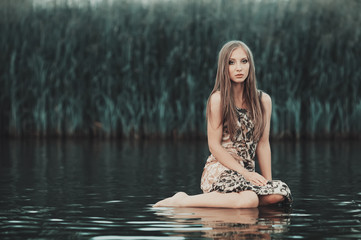 beautiful blond girl with dres on water