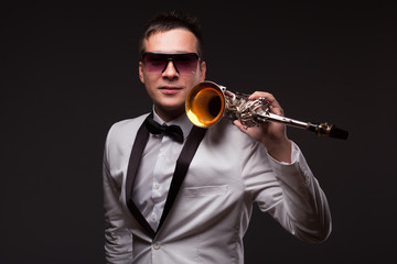 Portrait of guy with sax in suit and sunglasses