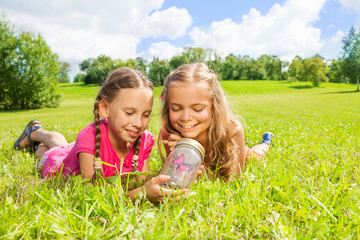 Two girls caught butterfly in the jar