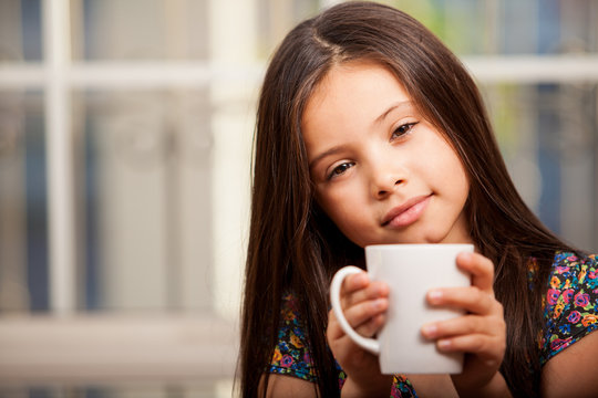 Cute little girl drinking tea
