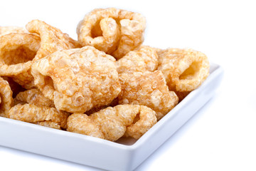 Pork rinds on white dish