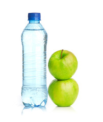 Bottle of sparkling water and green apple