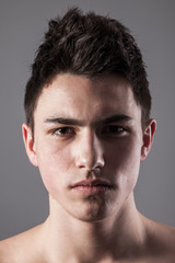 Obraz premium Handsome face of a young man on grey