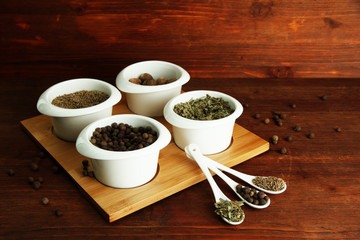 Fototapeta na wymiar Assortment of spices in white spoons and bowls,