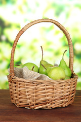 Pears in  wicker basket, on bright background