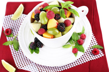 Fruit salad in cup on napkin isolated on white