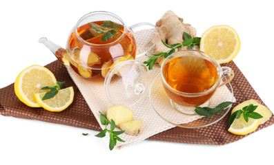 Kettle and cup of tea with ginger on napkin isolated on white