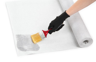 Hand smearing wallpaper by glue, isolated on white