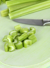 Fresh green celery on cutting board close-up