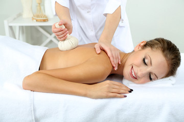Fototapeta na wymiar Beautiful young woman having back massage close up