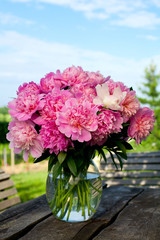 bunch of peonies on wooden table