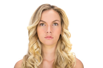 Naklejka premium Thoughtful curly haired blonde posing