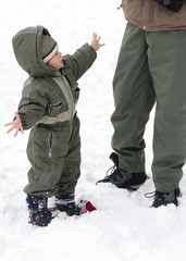 Fototapeta na wymiar Child in winter snow with parent