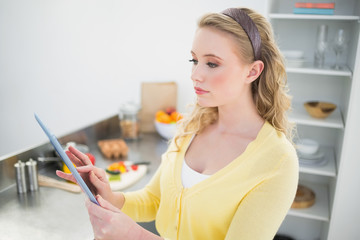 Content cute blonde using tablet