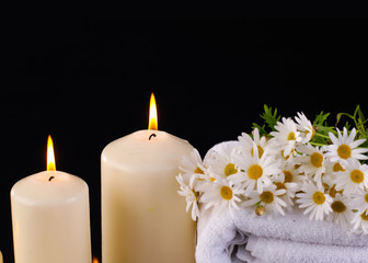 aromatherapy with candles with on towel and flower