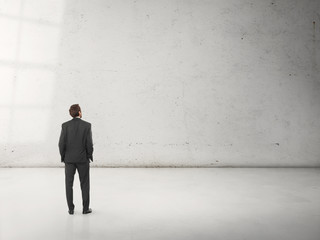 businessman standing in empty room