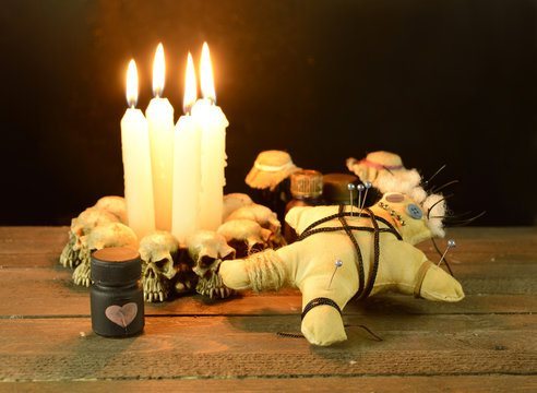 Pierced voodoo doll with love potion bottle