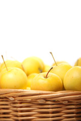 yellow apples in a wicker basket