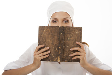 Woman doctor or nurse reading old book