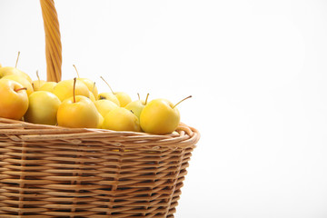 yellow apples in a wicker basket