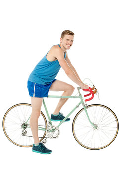A young male bicyclist riding a bicycle