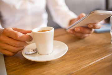 Close up of hands woman using her cell phone in restaurant