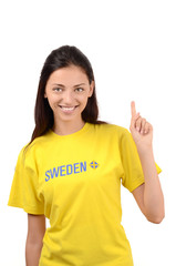 Girl pointing up. Girl with Sweden flag on her t-shirt.