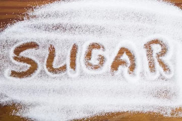Rolgordijnen The word sugar written into a pile of white granulated sugar © joanna wnuk