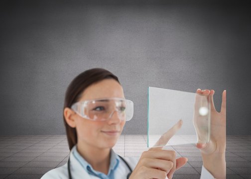 Brunette Doctor In Protective Glasses Holding Virtual Screen