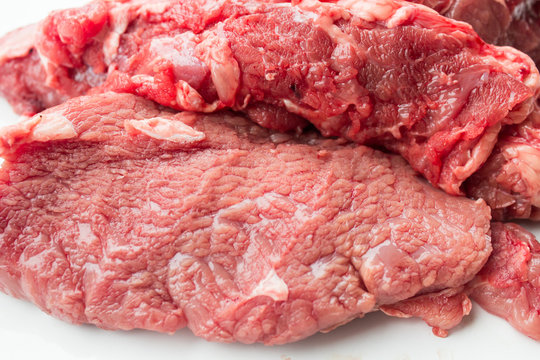 closeup of some raw beef fillets  on a white background