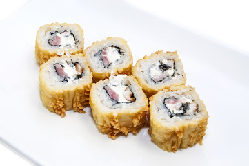 Japanese rolls in a restaurant with fish and vegetables