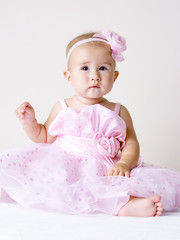 Little baby girl in pink dress.