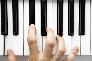 Hand playing piano