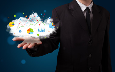 Young businessman presenting cloud with charts and graph icons a