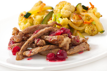 Beef stroganoff with cranberry sauce and grilled vegetables