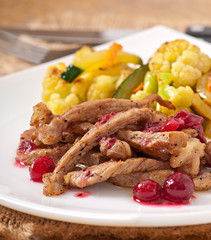 Beef stroganoff with cranberry sauce and grilled vegetables