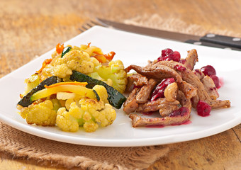Beef stroganoff with cranberry sauce and grilled vegetables