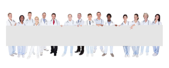 Group Of Doctors With Placard