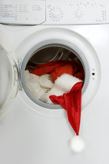 Christmas wash: washing machine with a red Santa suit