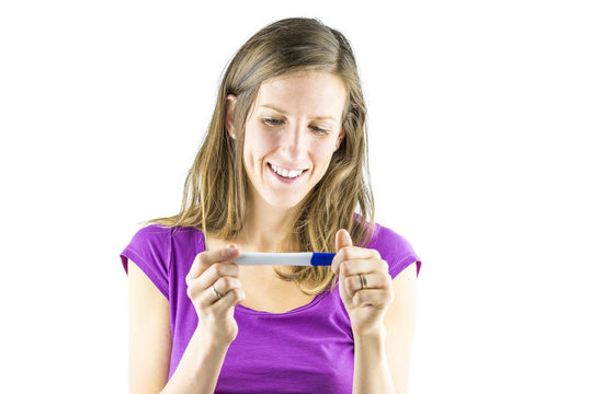 Young woman looking at pregnancy test
