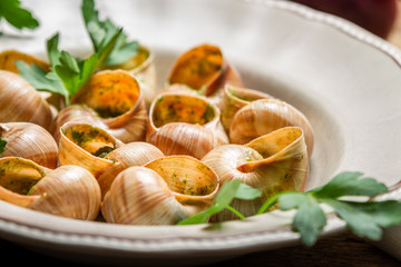 Closeup of baked snails with garlic butter