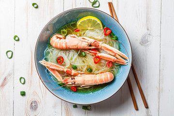 Closeup of Thai soup with scampi and noodles