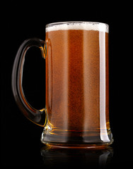 Mug of beer over black background