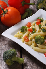Pasta with broccoli, tomatoes and peppers in a square plate