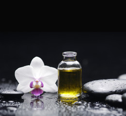 Spa still with massage oil, orchid pebbles