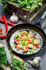Shrimps served on a pan with herbs