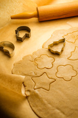 Cutting of different shapes of gingerbread cookies