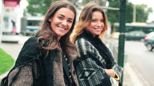 Happy young girlfriends in the city