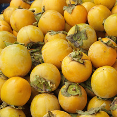 many persimona fruits as background